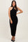 woman wearing a black fitted midi dress with a halter neck and ruching details, standing with one hand on her hip