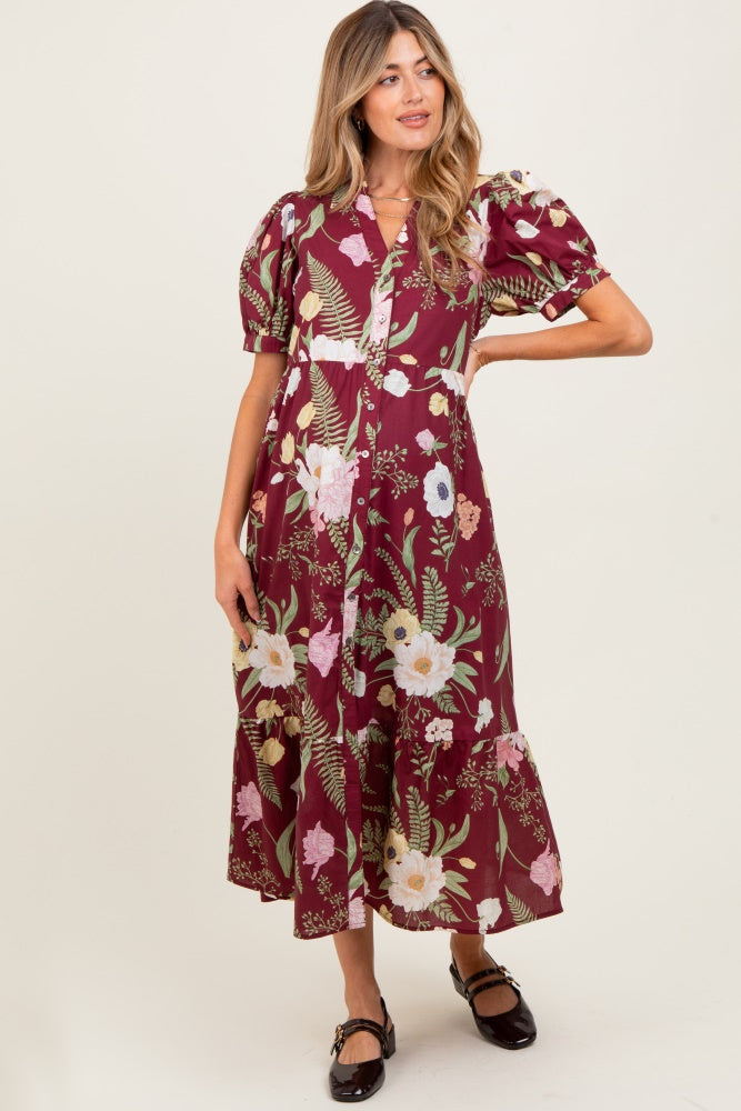 woman wearing a burgundy floral maternity dress with puff sleeves and a tiered hem