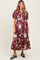 woman wearing a burgundy floral maternity dress with puff sleeves and a button-down front