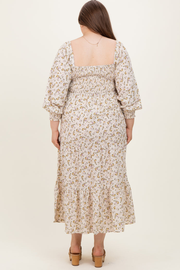woman wearing a floral print maternity plus dress with a smocked back and tiered hem, shown from the back