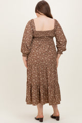 woman wearing a brown floral print maternity maxi dress with puff sleeves and a tiered skirt, showing her baby bump from the back