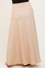 woman wearing a beige maternity maxi skirt with a comfortable waistband and flared hem