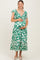 woman wearing a green and white floral maternity dress with ruffled sleeves and a baby bump