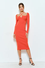woman wearing a fitted orange ribbed midi dress with long sleeves and a keyhole cutout detail