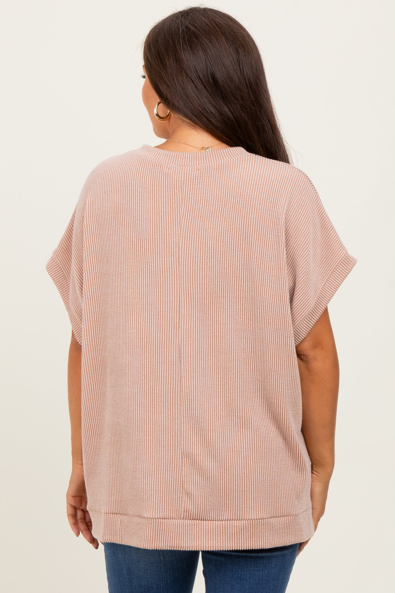 woman wearing a light pink striped maternity top with short sleeves and a relaxed fit, viewed from the back