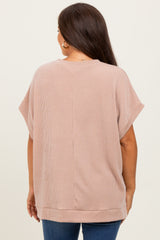 woman wearing a light pink striped maternity top with short sleeves and a relaxed fit, viewed from the back