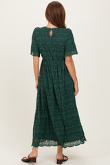 woman wearing a dark green lace maxi dress with short sleeves and a keyhole back detail