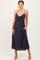 woman wearing a dark navy midi dress with a front knot detail and side pockets
