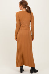 woman wearing a camel long sleeve ribbed maxi dress with a fitted silhouette and side slit, viewed from the back