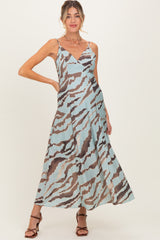 woman wearing a blue and brown patterned maternity dress with a flowing skirt and spaghetti straps