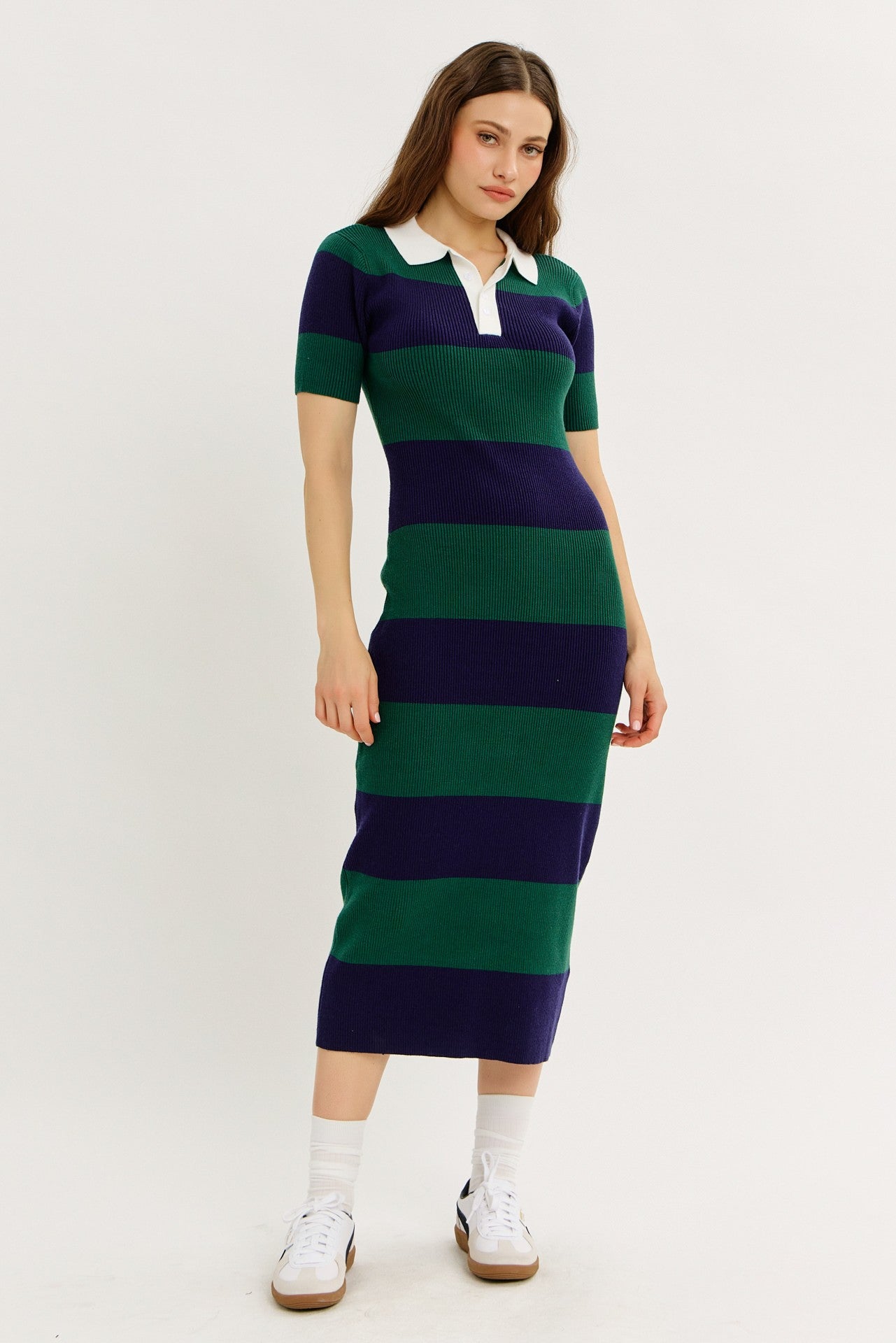 woman wearing a navy blue and green striped midi dress with a white collar and short sleeves