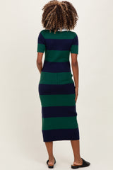 woman wearing a navy and green striped maternity dress with short sleeves and a fitted silhouette, showing no baby bump