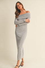 woman wearing a gray off-the-shoulder long sleeve maxi dress with a fitted silhouette and side slit