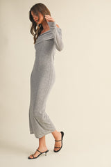 woman wearing a gray off-the-shoulder maxi dress with long sleeves and a fitted silhouette