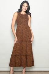 woman wearing an orange leopard print sleeveless maxi dress with a tiered skirt