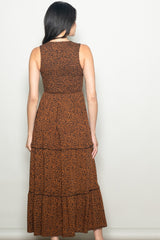 woman wearing a back view of a brown leopard print maxi dress with a tiered skirt