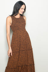 woman wearing a brown tiered maxi dress with a leopard print pattern