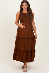 woman wearing an orange leopard print maternity maxi dress and holding her baby bump