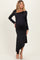 woman wearing a black long sleeve maternity dress with an asymmetrical hem and a visible baby bump