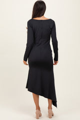 woman wearing a black long sleeve asymmetrical hem dress, viewed from the back