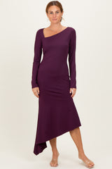 woman wearing a purple long sleeve asymmetrical dress with a sweetheart neckline and a fitted silhouette