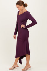 woman wearing a long sleeve purple midi dress with an asymmetrical hem and side slit