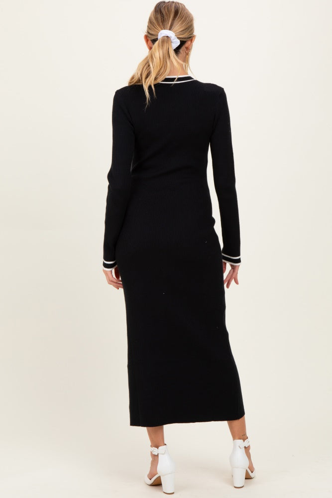 woman wearing a black ribbed maternity dress with long sleeves and a back slit, styled with white accents