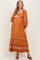 woman wearing an orange floral maternity maxi dress with puff sleeves and a baby bump visible
