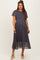 woman wearing a navy floral pleated maternity dress with short sleeves and a tied waist detail