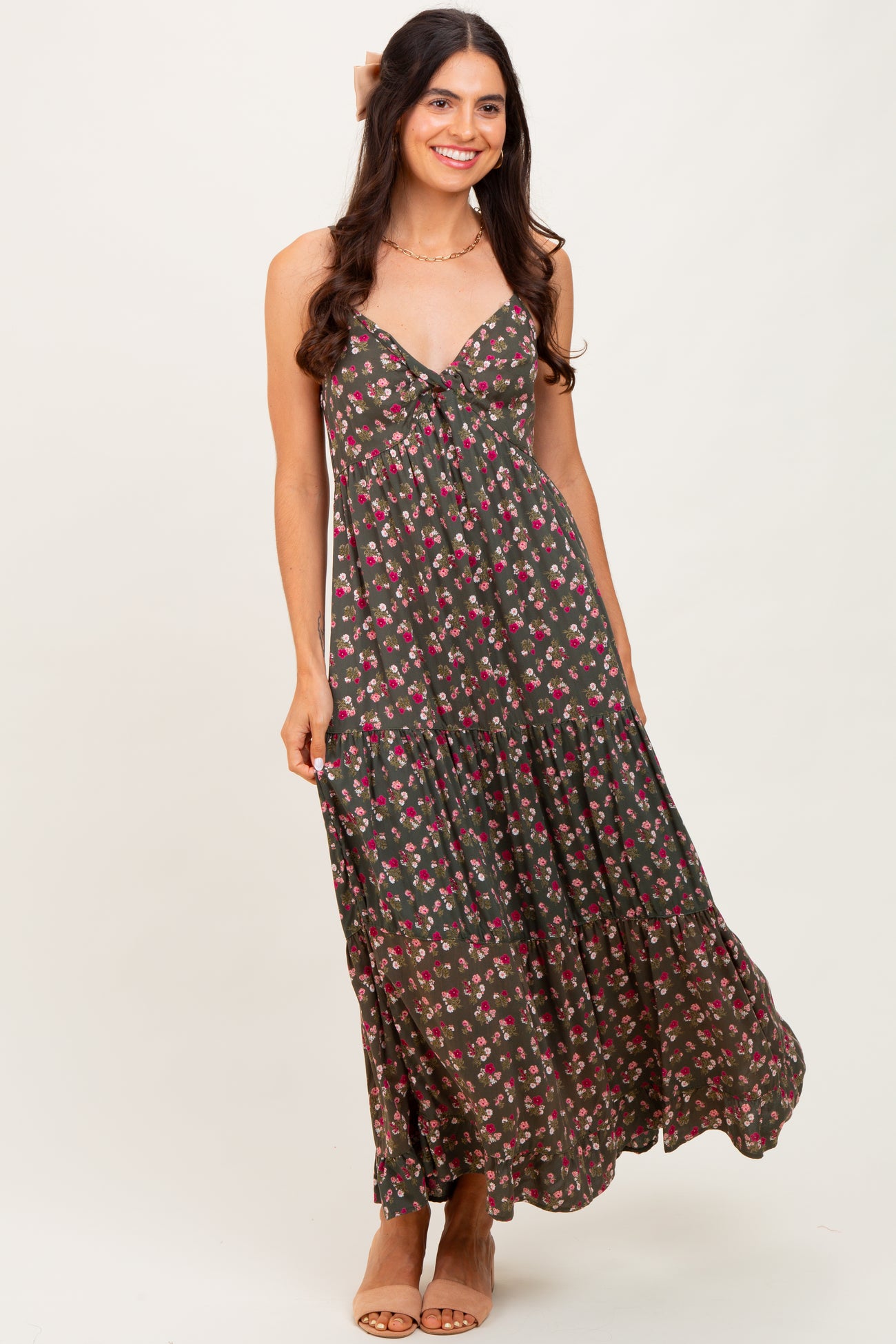 woman wearing a dark floral print maxi dress with a tie front and a tiered skirt