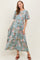 woman wearing a floral maternity maxi dress with short flared sleeves and a cinched waist