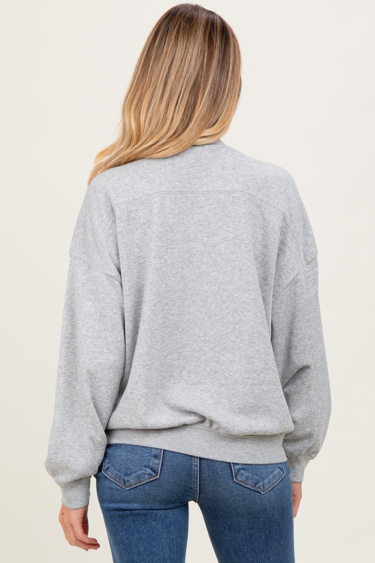 woman wearing a gray maternity sweatshirt with a relaxed fit and balloon sleeves, view of the back