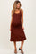 woman wearing a brown sleeveless maternity dress with ruching and a visible baby bump
