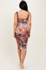 woman wearing a floral print bodycon midi dress with a fitted silhouette and scoop back design
