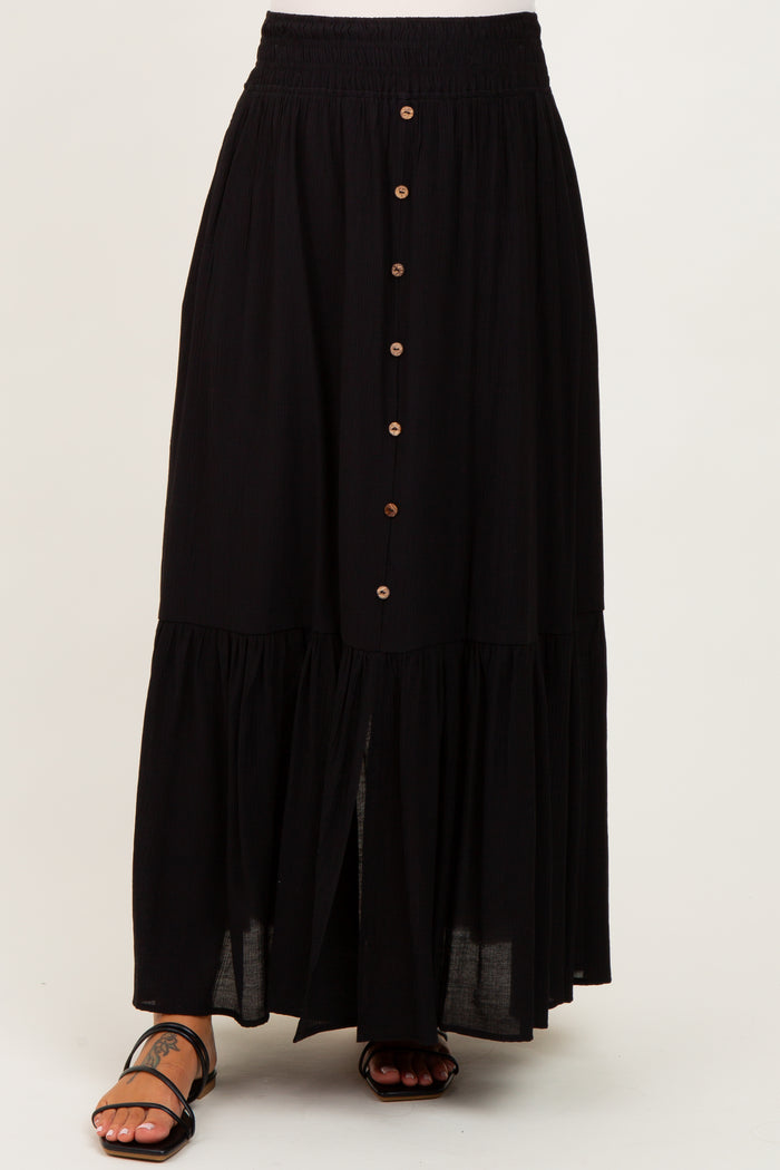 maternity wear black tiered maxi skirt with button detailing and an elastic waistband, styled with sandals