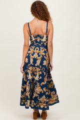 woman wearing a navy blue floral print maxi dress with a fitted bodice and flared skirt, shown from the back