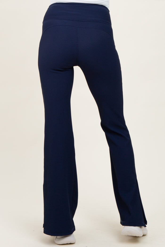 woman wearing navy blue maternity yoga pants, showing the back view and fitted style