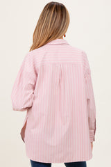 woman wearing a pink and white striped maternity shirt with a relaxed fit and button details on the sleeves