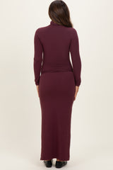 woman wearing a burgundy long sleeve maternity maxi dress, view from the back