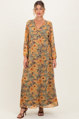 woman wearing a floral long sleeve maternity maxi dress with a v-neck and a baby bump visible