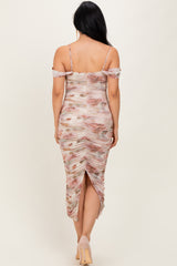 woman wearing a floral print ruched midi dress with off-the-shoulder straps and a back slit