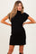woman wearing a black ribbed maternity dress with a short sleeve and pocket, showcasing her baby bump