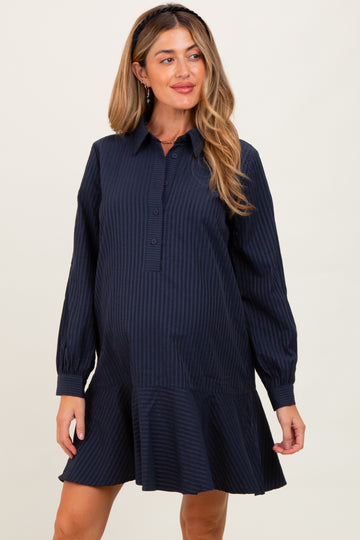 woman wearing a navy striped maternity dress with a collar and flared hem, highlighting her baby bump