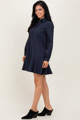 woman wearing a navy blue striped shirt dress with a flared hem and long sleeves, paired with black heeled mules