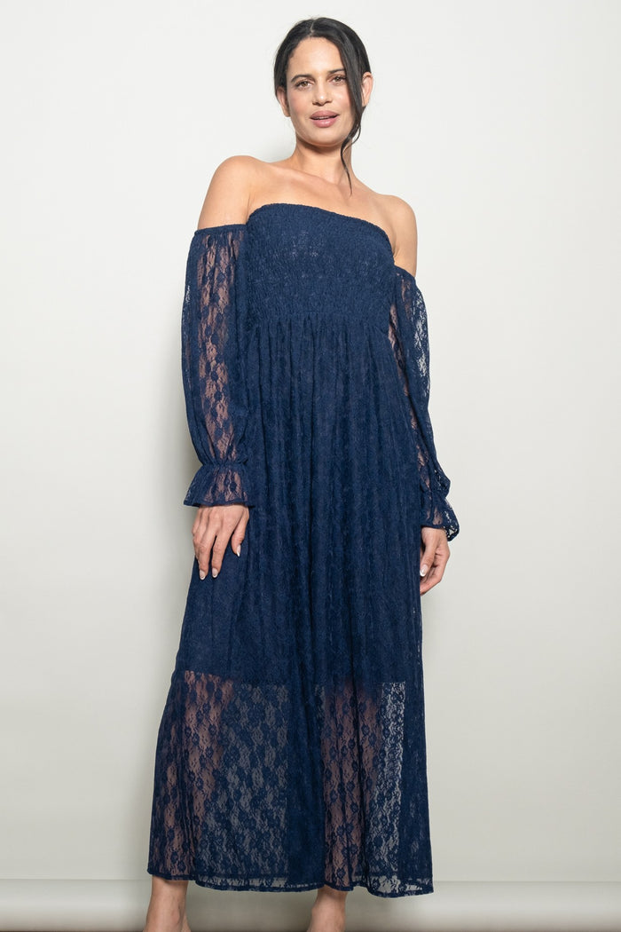 woman wearing a navy blue off-the-shoulder lace maxi dress with long sheer sleeves and a flowy silhouette