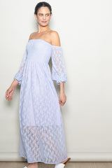 woman wearing a light purple off-the-shoulder maxi dress with lace detailing and bell sleeves
