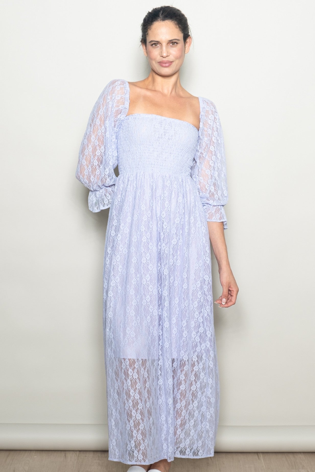 woman wearing a lavender lace maxi dress with puff sleeves and a smocked bodice
