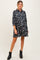 woman wearing a black floral maternity dress with 3/4 sleeves and a flowy fit