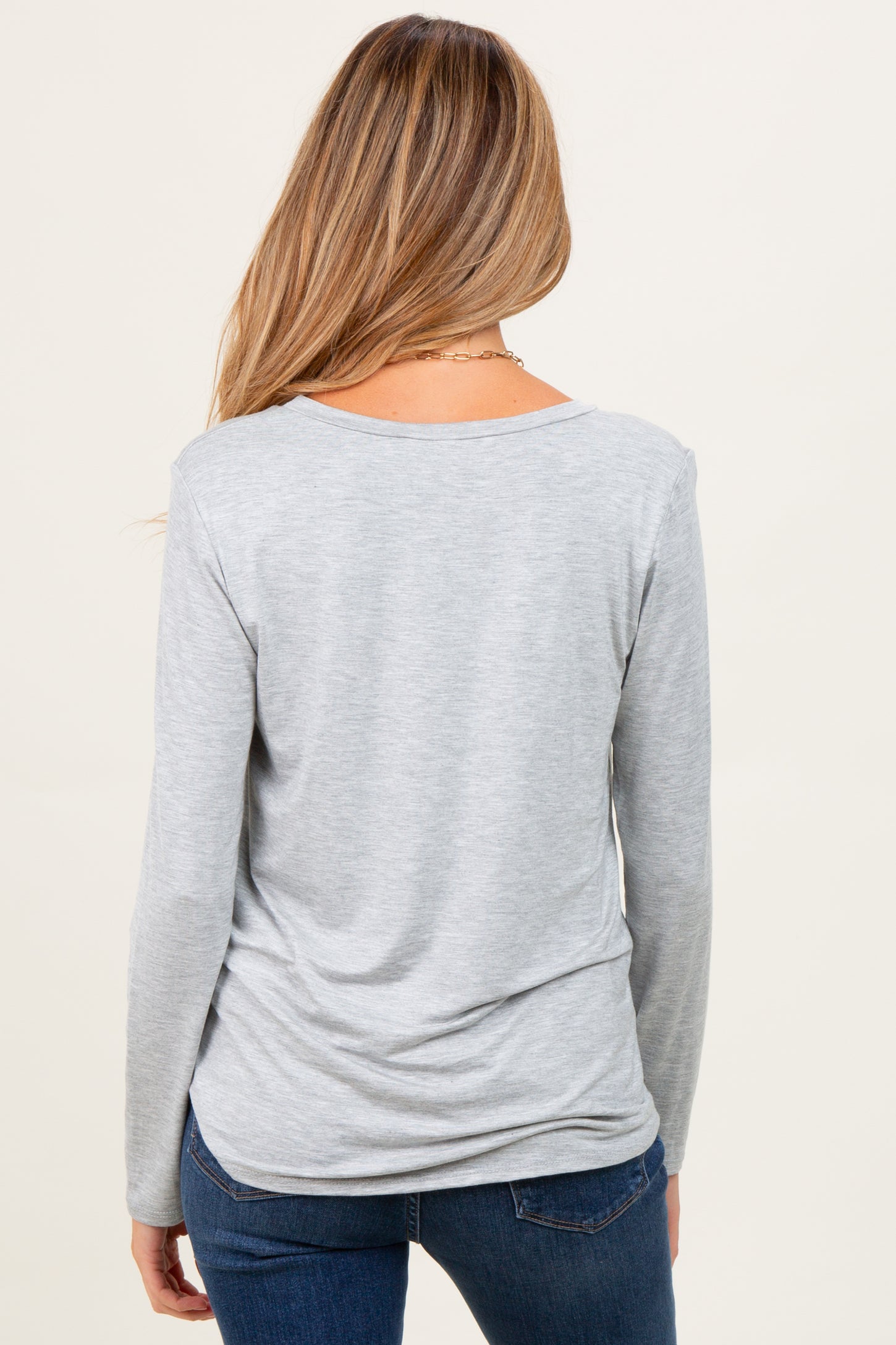 woman wearing a gray long sleeve maternity top, viewed from the back, with a relaxed fit and soft fabric