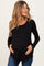 woman wearing a black long sleeve maternity top while holding her baby bump